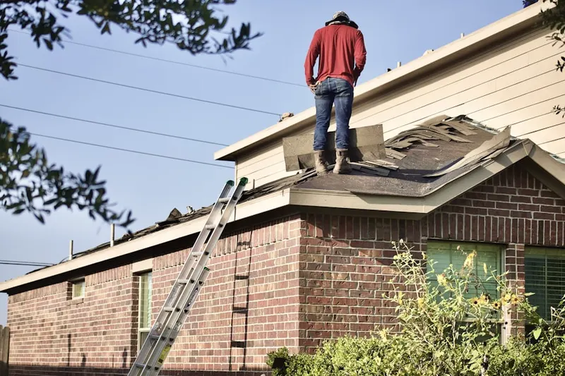 Professional roofer working on a residential roof in Spring Valley Lake